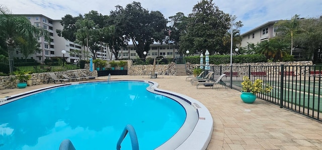 pool featuring a patio area and fence