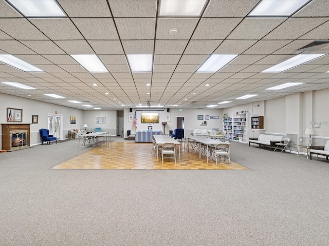 miscellaneous room with a glass covered fireplace, carpet flooring, and recessed lighting