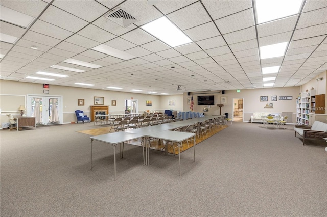 rec room featuring carpet floors, a drop ceiling, and visible vents