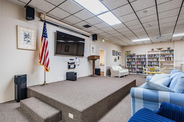 carpeted living room with a drop ceiling