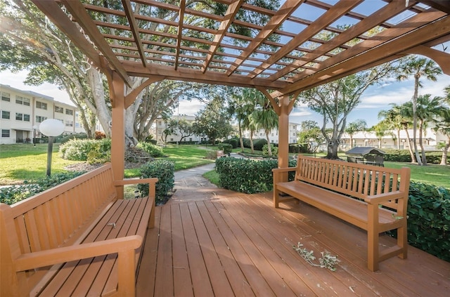 wooden terrace with a lawn and a pergola