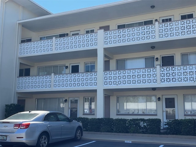 view of property featuring uncovered parking