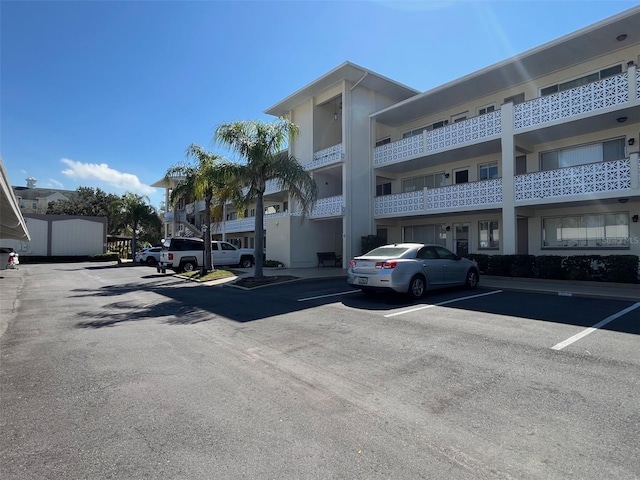 view of building exterior featuring uncovered parking