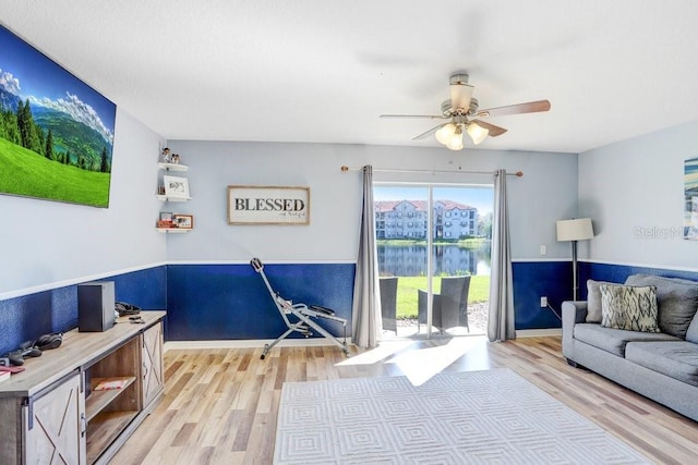 living room with ceiling fan and light wood-style floors