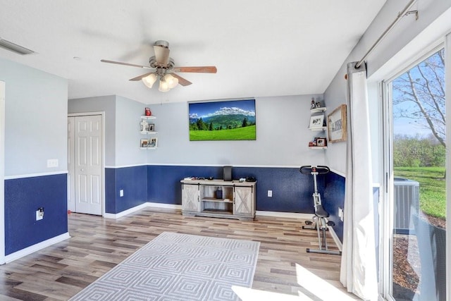 interior space with baseboards, visible vents, and wood finished floors