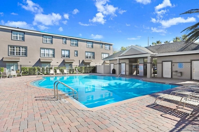 pool featuring a patio area and fence