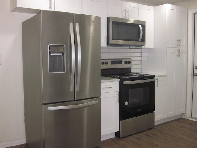 kitchen with white cabinets, stainless steel appliances, dark wood finished floors, and light countertops