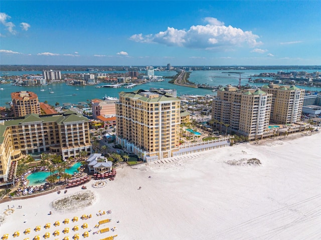 birds eye view of property featuring a view of city, a beach view, and a water view