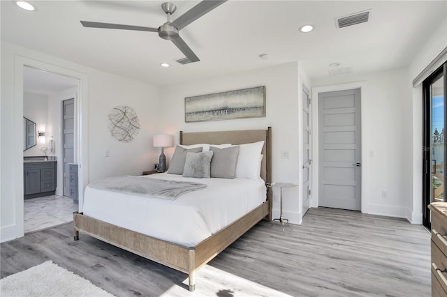 bedroom with recessed lighting, visible vents, light wood finished floors, and ensuite bathroom