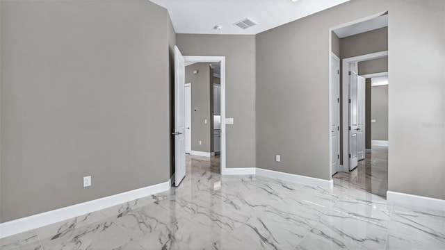 unfurnished bedroom with marble finish floor, visible vents, and baseboards