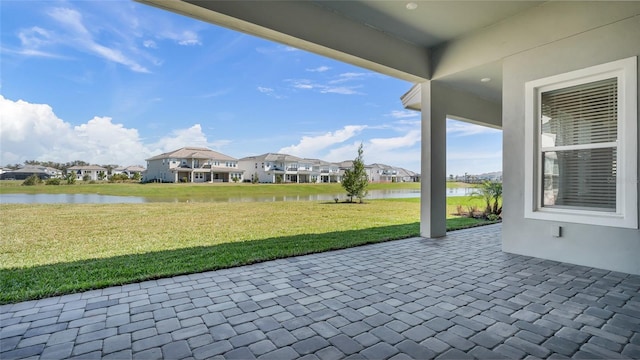 view of patio with a residential view and a water view