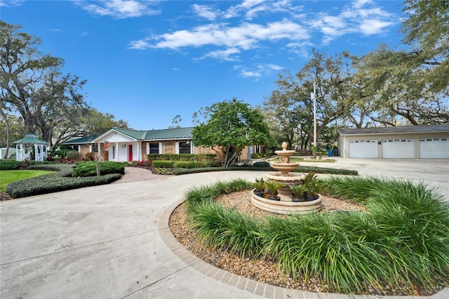 ranch-style home with a garage and concrete driveway