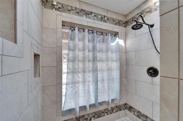 bathroom with a tile shower