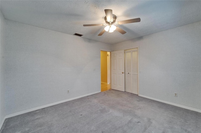 unfurnished bedroom featuring carpet, a closet, visible vents, and baseboards