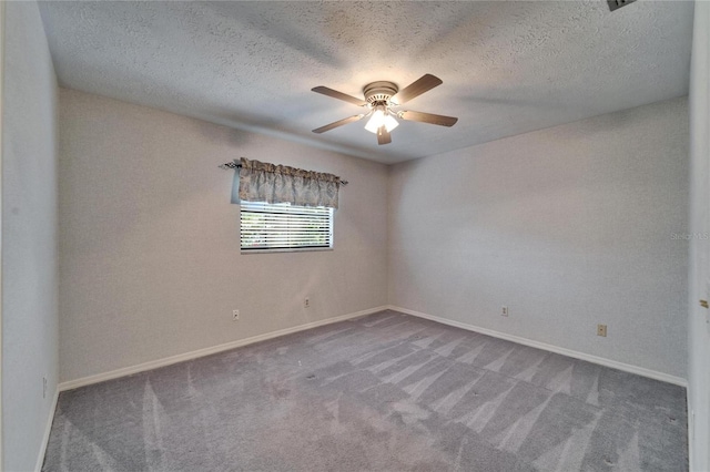 unfurnished room with carpet floors, baseboards, and a ceiling fan