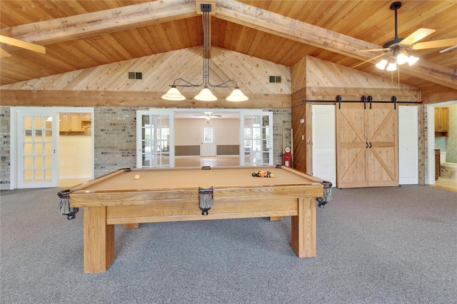 game room with ceiling fan, lofted ceiling with beams, a barn door, wood ceiling, and carpet