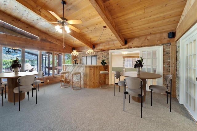 dining room with lofted ceiling with beams, wooden ceiling, a ceiling fan, and carpet