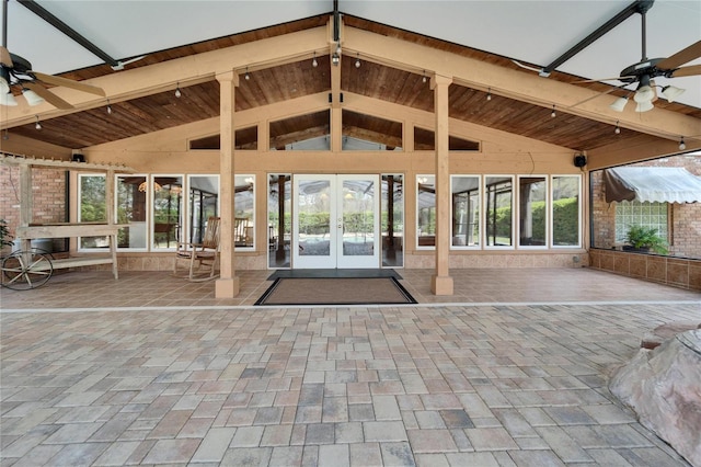 entrance to property with a patio, a ceiling fan, and french doors