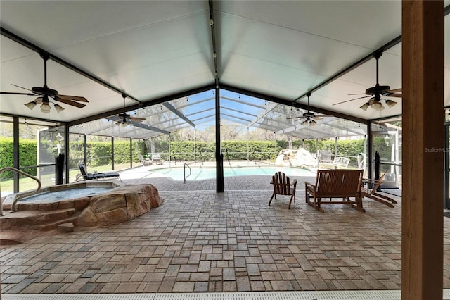 view of patio / terrace with glass enclosure, an outdoor pool, a ceiling fan, and an in ground hot tub