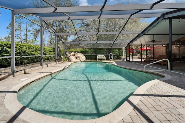 pool with glass enclosure and a patio