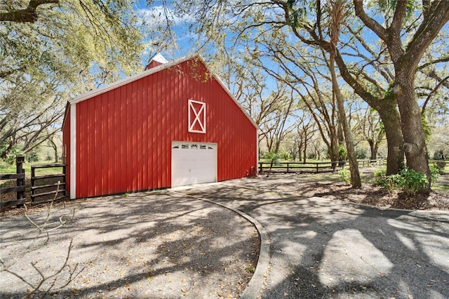 exterior space featuring driveway and fence