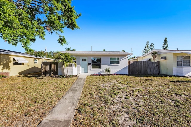 679 71st Ave N, Saint Petersburg, FL 33702 - view of front facade with brick siding, a front lawn, and fence