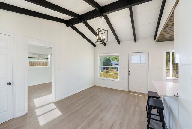 679 71st Ave N, Saint Petersburg, FL 33702 - entrance foyer with lofted ceiling with beams, light wood-style floors, a healthy amount of sunlight, and a chandelier