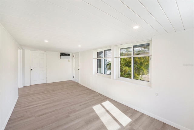679 71st Ave N, Saint Petersburg, FL 33702 - unfurnished room with recessed lighting, baseboards, light wood-style floors, and a wall unit AC