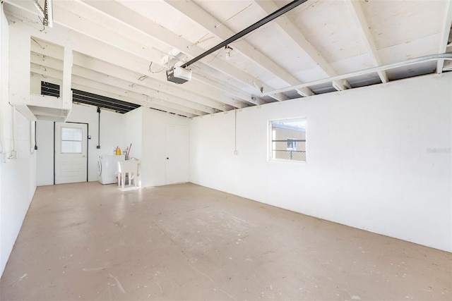 679 71st Ave N, Saint Petersburg, FL 33702 - garage with washing machine and clothes dryer and a garage door opener