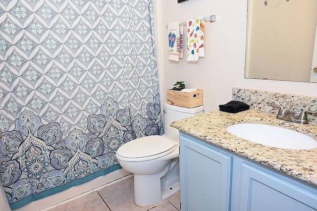 full bathroom with a shower with shower curtain, vanity, toilet, and tile patterned floors