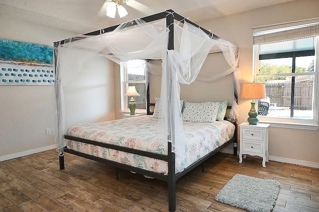 bedroom with wood-type flooring and baseboards