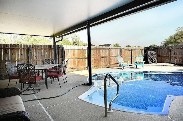 view of swimming pool with outdoor dining space, a fenced backyard, a fenced in pool, and a patio