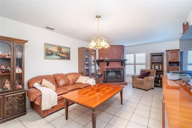 12172 SE 96th Ter, Belleview, FL 34420 - living area with light tile patterned floors, visible vents, an inviting chandelier, a textured ceiling, and a brick fireplace