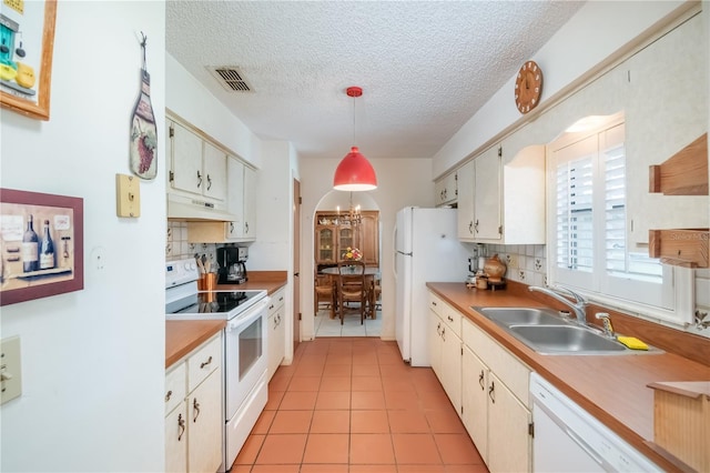 12172 SE 96th Ter, Belleview, FL 34420 - kitchen featuring white appliances, visible vents, arched walkways, under cabinet range hood, and a sink