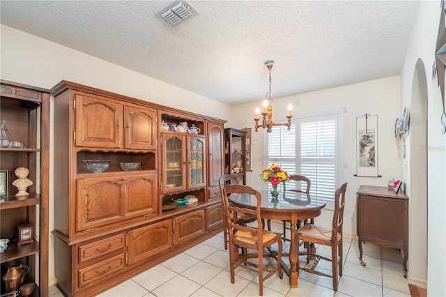 12172 SE 96th Ter, Belleview, FL 34420 - dining space with a chandelier, visible vents, a textured ceiling, and light tile patterned floors
