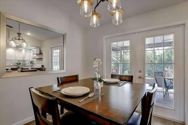 dining space with lofted ceiling and french doors