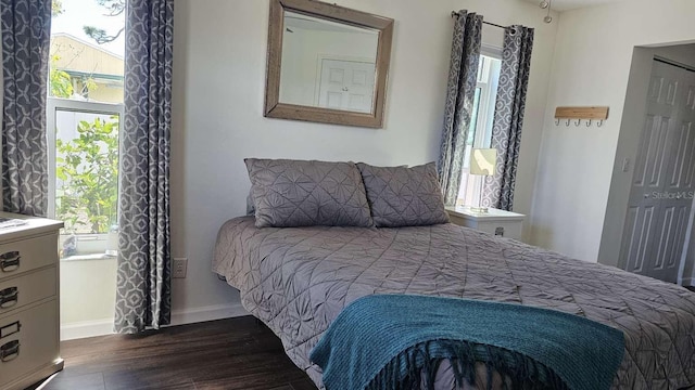 bedroom featuring dark wood-type flooring and baseboards