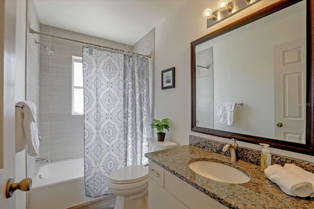 bathroom with vanity, toilet, and shower / bath combo with shower curtain