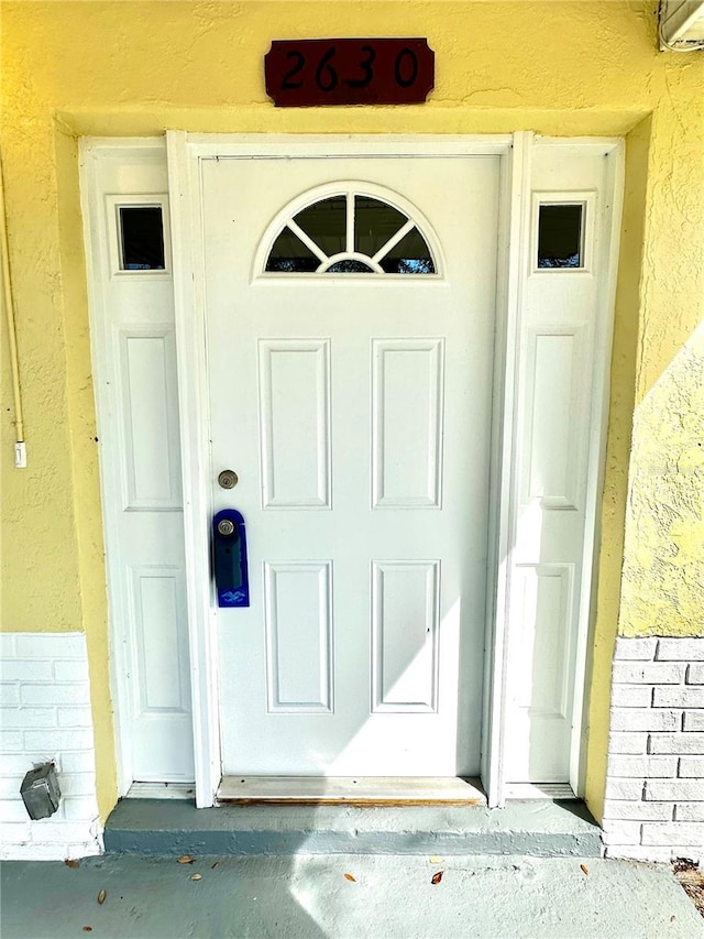 property entrance featuring stucco siding