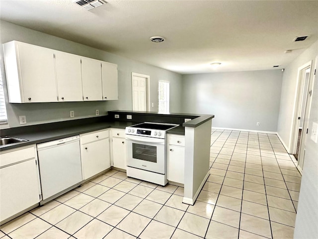 kitchen featuring white appliances, dark countertops, visible vents, and white cabinetry