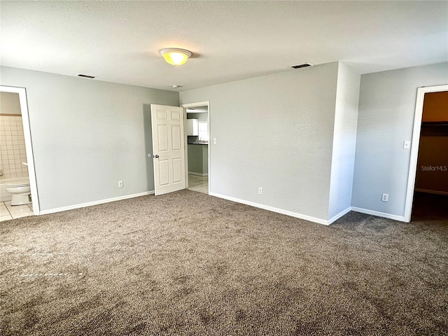 unfurnished bedroom with visible vents and carpet flooring