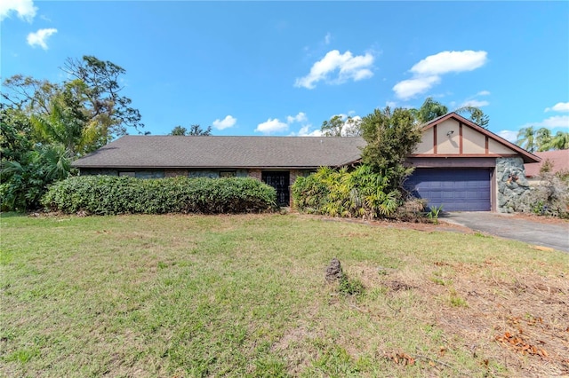 view of front of home with a garage, driveway, and a front lawn