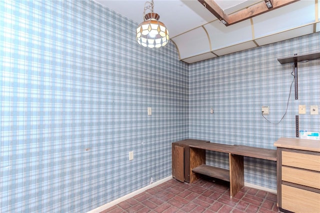 bathroom with brick floor, baseboards, and wallpapered walls