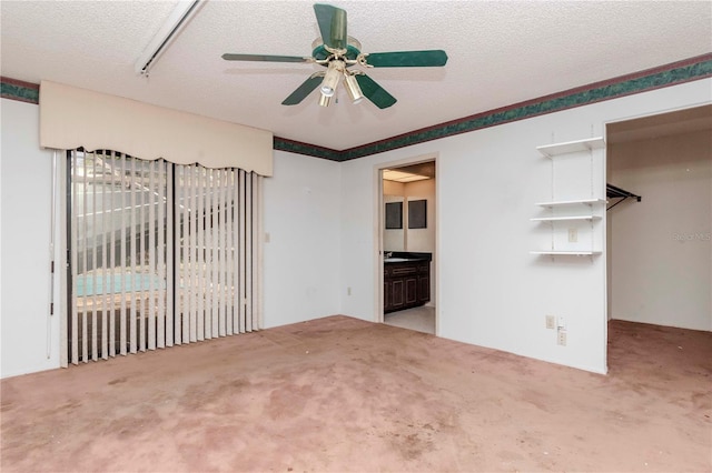 unfurnished bedroom featuring access to outside, a textured ceiling, and carpet flooring