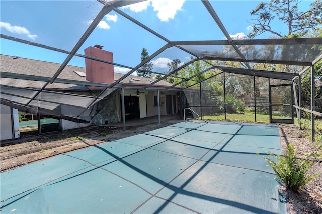 view of swimming pool with a lanai, a patio area, and a ceiling fan