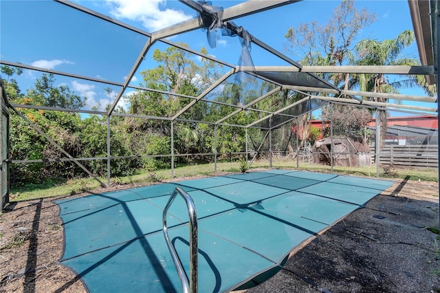 view of swimming pool with a lanai and fence