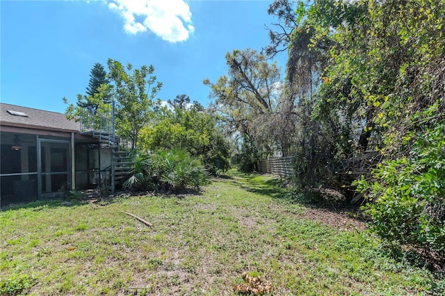 view of yard with stairs and a sunroom