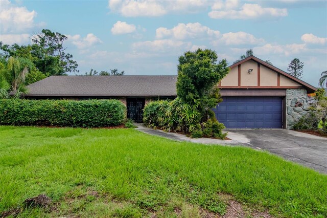 5101 Estates Cir, Sarasota, FL 34243 - view of front of house with driveway, an attached garage, and a front lawn