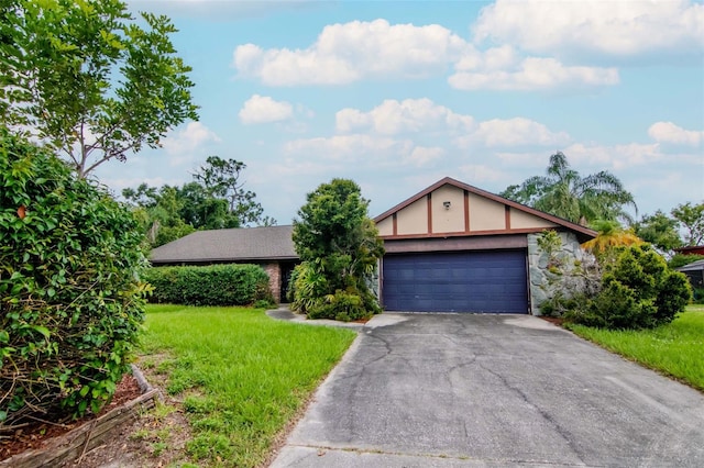 5101 Estates Cir, Sarasota, FL 34243 - view of front of house featuring asphalt driveway, a front lawn, and an attached garage