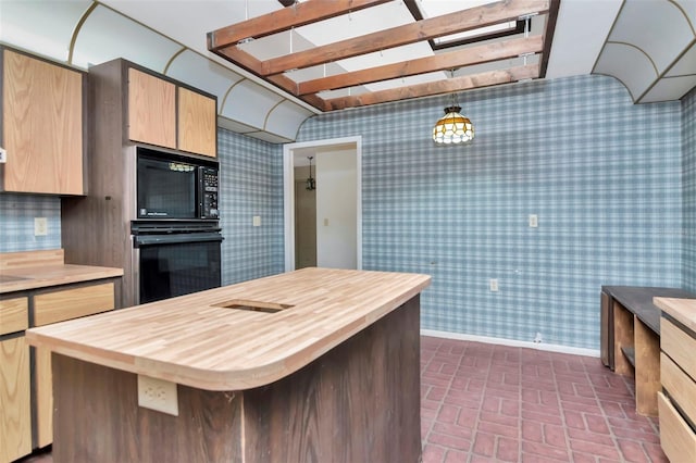 5101 Estates Cir, Sarasota, FL 34243 - kitchen featuring black appliances, butcher block countertops, wallpapered walls, brick patterned flooring, and a kitchen island